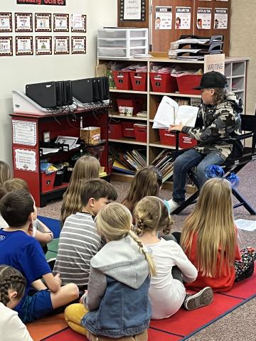 Middle school student reading to class