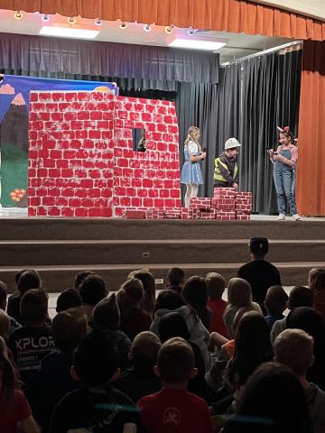Brick house and actors in middle school play