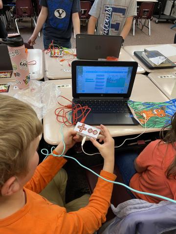 Student working with coding equipment